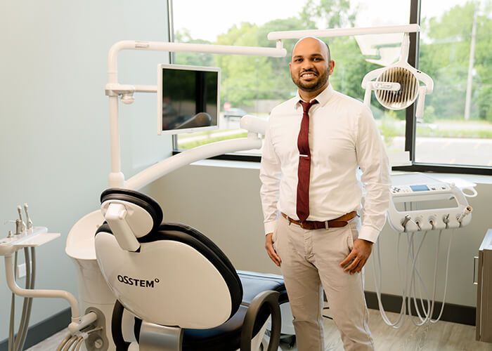 Dr. Rohan Shah, family dentist in Naperville, smiling in the dental office